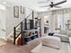 Cozy living room with modern furnishings, a ceiling fan, and a staircase, creating an inviting space at 2578 Palau Way, Castle Rock, CO 80109