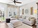 Comfortable living room features a plush sectional sofa and large windows that bring in tons of light at 2578 Palau Way, Castle Rock, CO 80109