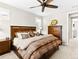 A well-lit main bedroom with a ceiling fan, and carpeted flooring showcases comfort and style at 2578 Palau Way, Castle Rock, CO 80109