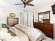 Bright main bedroom features carpet flooring, a ceiling fan, and elegant dressers, enhancing its charm at 2578 Palau Way, Castle Rock, CO 80109
