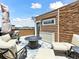 Rooftop deck featuring outdoor lounge furniture, a fire pit, and stone accents at 2578 Palau Way, Castle Rock, CO 80109