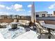 Rooftop deck with fire pit, sectional couch, multiple chairs and string lights at 2578 Palau Way, Castle Rock, CO 80109