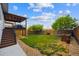 A spacious backyard featuring a patio, stairs, grass, trees and a rock border fence at 2529 S Truckee Way, Aurora, CO 80013
