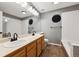 Well-lit bathroom featuring double vanity, large mirror, and tub at 2529 S Truckee Way, Aurora, CO 80013