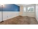Bright bedroom with wainscotting, a blue accent wall, and natural light at 2529 S Truckee Way, Aurora, CO 80013