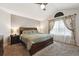 Main bedroom featuring vaulted ceiling, king bed, and floral curtains at 2529 S Truckee Way, Aurora, CO 80013