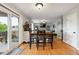 Dining area with sliding glass doors and hardwood floors opens to the living room, creating an inviting space at 2529 S Truckee Way, Aurora, CO 80013