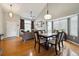Inviting dining area with hardwood floors, a modern light fixture, and a view of the living room at 2529 S Truckee Way, Aurora, CO 80013