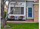 Close up on front porch with chairs and a small table, plus a blue front door at 2529 S Truckee Way, Aurora, CO 80013