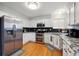 Bright kitchen with stainless steel appliances, granite countertops, and white cabinetry at 2529 S Truckee Way, Aurora, CO 80013