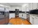 Modern kitchen with stainless steel appliances, granite countertops, and white cabinetry at 2529 S Truckee Way, Aurora, CO 80013