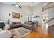 Open-concept living room and dining area featuring hardwood floors and ample natural light at 2529 S Truckee Way, Aurora, CO 80013
