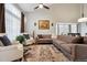 Bright living room with vaulted ceilings, a large sectional sofa, and a decorative rug at 2529 S Truckee Way, Aurora, CO 80013