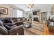 Cozy living room with a fireplace, built-in shelves, and a comfortable sectional sofa at 2529 S Truckee Way, Aurora, CO 80013