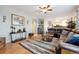 View of living room with ceiling fan, modern rug, and a console table at 2529 S Truckee Way, Aurora, CO 80013