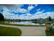 Beautiful pond reflecting the sky and surrounding neighborhood homes, enhancing the community's charm at 2529 S Truckee Way, Aurora, CO 80013