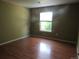Bright bedroom boasts wood floors and a window with natural light at 555 Alton Way # E, Denver, CO 80230