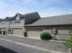 Exterior view of townhomes, showing garages, siding and brick trim at 555 Alton Way # E, Denver, CO 80230