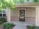 Inviting front porch with a secure screen door and well-maintained landscaping adding curb appeal at 555 Alton Way # E, Denver, CO 80230