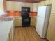 Well-equipped kitchen with stainless steel appliances, light wood cabinets, and laminate countertops at 555 Alton Way # E, Denver, CO 80230