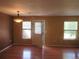 Bright living area featuring hardwood floors, large windows, and an adjacent outdoor entrance at 555 Alton Way # E, Denver, CO 80230