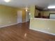 Inviting living space with hardwood floors flowing into an adjacent kitchen and dining area at 555 Alton Way # E, Denver, CO 80230