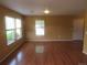 Spacious living room featuring hardwood floors, and large windows offering bright, natural light at 555 Alton Way # E, Denver, CO 80230