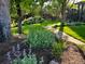 Lush backyard featuring a manicured lawn, mature trees, flowering plants, and a charming gazebo at 559 E 2Nd Ave, Castle Rock, CO 80108