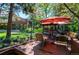 Backyard deck with outdoor seating area and red umbrella covered grill, perfect for entertaining at 559 E 2Nd Ave, Castle Rock, CO 80108