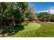 Backyard with a putting green, mature trees, and privacy fence at 559 E 2Nd Ave, Castle Rock, CO 80108