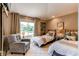 Cozy bedroom with two twin beds, a sitting chair, and lots of natural light at 559 E 2Nd Ave, Castle Rock, CO 80108