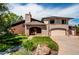 Charming home exterior with brick accents, well-maintained lawn, mature landscaping and a two car garage at 559 E 2Nd Ave, Castle Rock, CO 80108