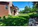 Beautiful brick home with lush green lawn, mature trees, and charming landscaping at 559 E 2Nd Ave, Castle Rock, CO 80108