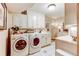 Well-lit laundry room with modern washer and dryer, sink and storage at 559 E 2Nd Ave, Castle Rock, CO 80108