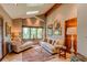 Comfortable living room with vaulted ceilings, a skylight, neutral colors, large windows and a cozy seating area at 559 E 2Nd Ave, Castle Rock, CO 80108