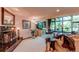 Elegant living room with a fireplace, plush carpeting, natural light from a large window, and stylish furnishings at 559 E 2Nd Ave, Castle Rock, CO 80108
