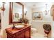 Elegant powder room with a unique vessel sink, ornate mirror, and decorative lighting at 559 E 2Nd Ave, Castle Rock, CO 80108