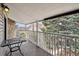Relaxing covered balcony with seating, and views of mature landscaping at 943 S Zeno Way # 207, Aurora, CO 80017