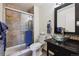 Stylish bathroom featuring a glass vessel sink, upgraded shower, and modern fixtures at 943 S Zeno Way # 207, Aurora, CO 80017