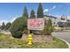 Exterior sign for the community with manicured landscape, flowers and adjacent sidewalks at 943 S Zeno Way # 207, Aurora, CO 80017