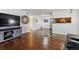 Open-concept living area with an entertainment center, hardwood floors, and a view of the kitchen at 943 S Zeno Way # 207, Aurora, CO 80017