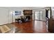 Cozy living room with hardwood floors, a stone fireplace, and sliding doors to the balcony at 943 S Zeno Way # 207, Aurora, CO 80017