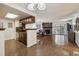 Open living room featuring a stone fireplace, hardwood floors, and access to a balcony at 943 S Zeno Way # 207, Aurora, CO 80017
