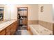 Bathroom with a double vanity, tiled walls, and a large soaking tub at 655 Four O Clock Rd # 104, Breckenridge, CO 80424