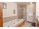 Relaxing bathroom with large soaking tub, glass shower, and neutral tile accents at 655 Four O Clock Rd # 104, Breckenridge, CO 80424