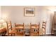 A cozy dining area is accentuated by natural wood furniture and a picturesque painting on the wall at 655 Four O Clock Rd # 104, Breckenridge, CO 80424