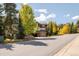 Condo exterior with mature trees and a sign that reads Riverbend, under a blue sky at 655 Four O Clock Rd # 104, Breckenridge, CO 80424