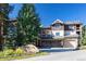 A condo with a well-manicured lawn and a sign that reads Riverbend, under a clear blue sky at 655 Four O Clock Rd # 104, Breckenridge, CO 80424