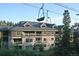 A multi-story condo building with balconies and a ski lift above it at 655 Four O Clock Rd # 104, Breckenridge, CO 80424