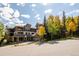 Exterior view of a condo with balconies and fall foliage, on a sunny day with a blue sky at 655 Four O Clock Rd # 104, Breckenridge, CO 80424